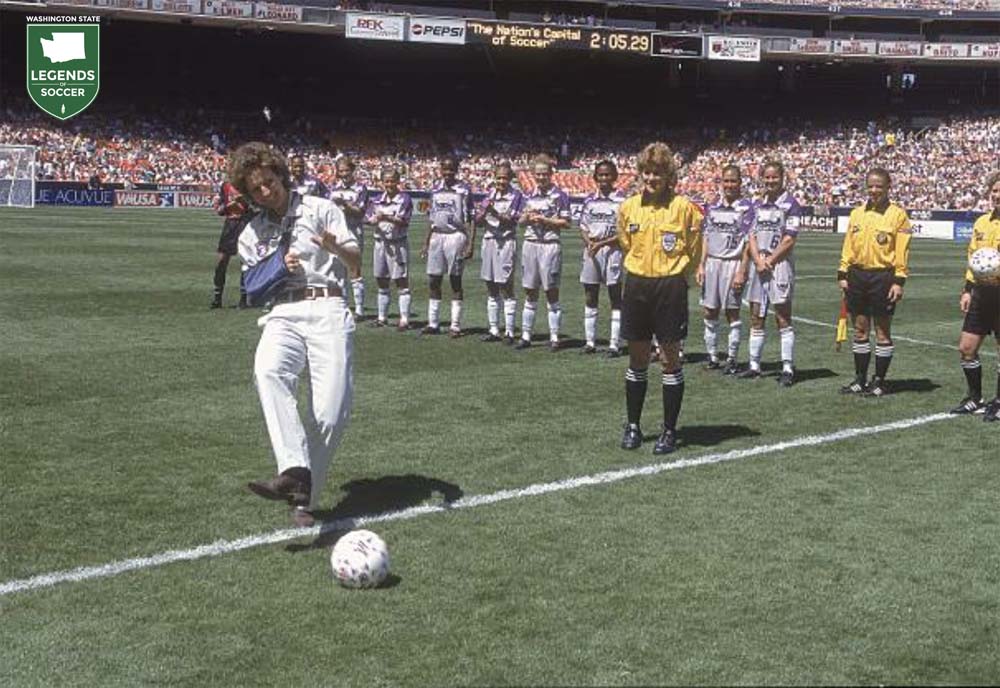 Michelle Akers performs the ceremonial first kick for the WUSA inaugural match as referee Sandra Hunt looks on. (Courtesy WUSA)