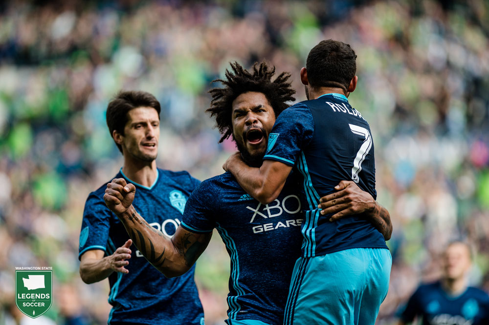 Alvaro Fernandez (l), Roman Torres and Cristian Roldan celebrate the latter's goal, which clinches an MLS Cup playoff spot for the Sounders. (Courtesy Sounders FC)