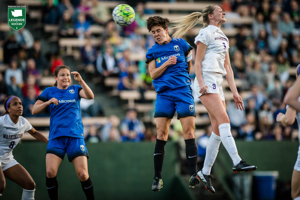 Keelin Winters, Seattle Reign captain, vies for a high ball at Memorial Stadium as Kendall Fletcher looks on. Winters retired after the 2016 season, her fifth in Seattle, including one with Sounders Women. (Courtesy Seattle Reign)