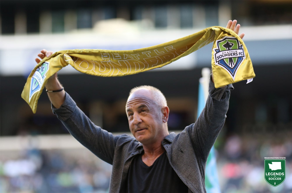 Adrian Webster, Sounders captain in NASL era, raises the Golden Scarf to celebrate the Soccer Bowl '77 run's 40th anniversary. (Courtesy Sounders FC)