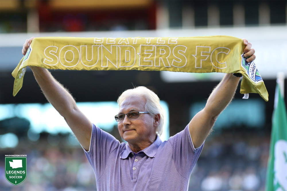 David Butler, Sounders forward in the NASL era, raises the Golden Scarf to celebrate the Soccer Bowl '77 run's 40th anniversary. (Courtesy Sounders FC)