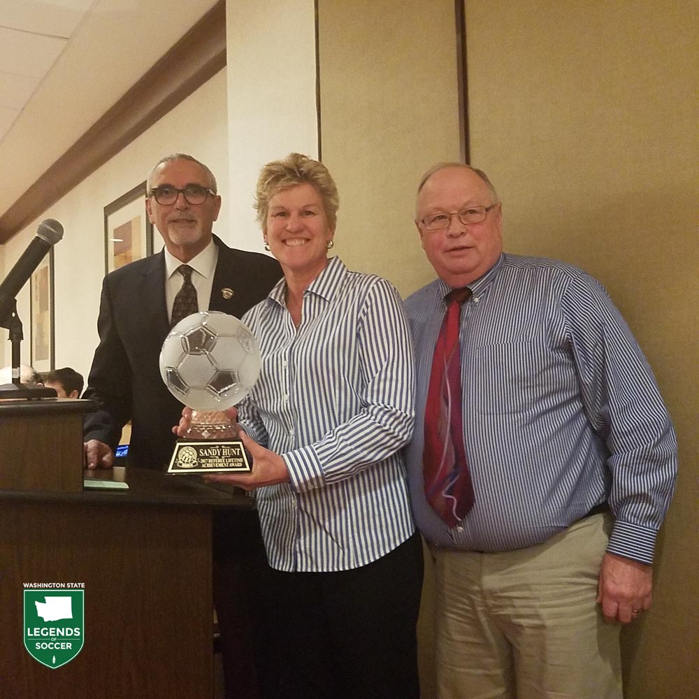 Bellingham's Sandra Hunt receives the U.S. Adult Soccer Association RefereeLifetime Achievement award. WSSA president Tim Busch is at right.