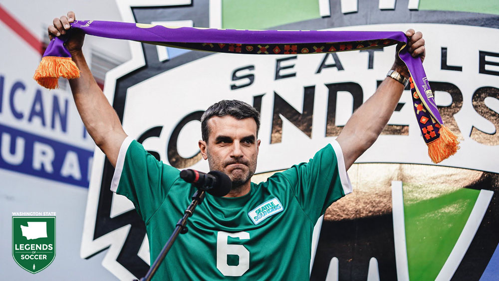 Former USL Sounders captain Danny Jackson wears a jersey to honor the late Jimmy Gabriel during the Scarves Up! pregame. Gabriel, the former captain and coach of the NASL Sounders, died July 10, 2021. (Courtesy Sounders FC)