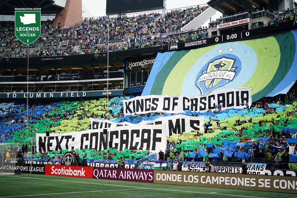 Lumen Field's Brougham End is awash in color and Emerald City Supporters tifos before the kickoff of Sounders-Pumas for the Concacaf Champions League title. (Courtesy Mike Fiechtner/Sounders FC)