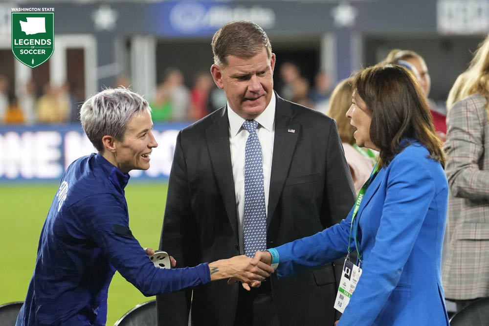 Megan Rapinoe, one of the USWNT leaders in the fight for equal pay, shakes hands with U.S. Senator Maria Cantwell of Washington at Audi Field in Washington, D.C. during ceremonies to sign the breakthrough CBA with U.S. Soccer. (Courtesy Brad Smith/ISI Photo)