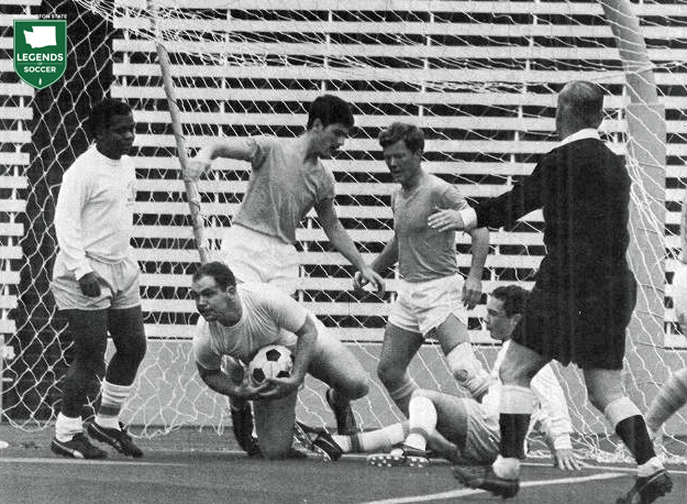 Western Washington's keeper takes possession against Washington at Husky Stadium. Referee George Craggs is at right. (Courtesy UW Tyee archives)