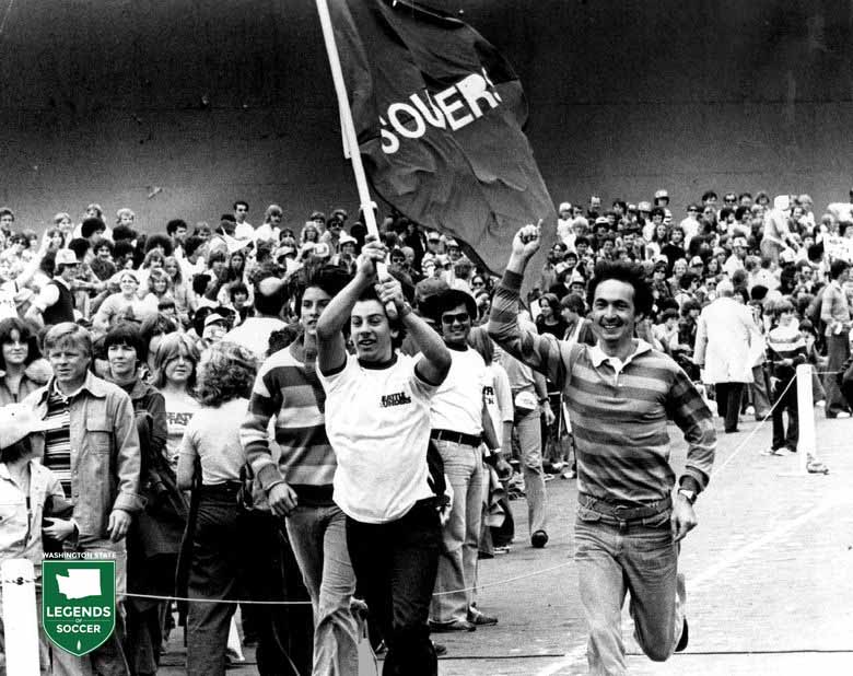 Teddy Mitalis of Seattle carries the Sounders flag as the Sounders fans gather for Soccer Bowl '77.