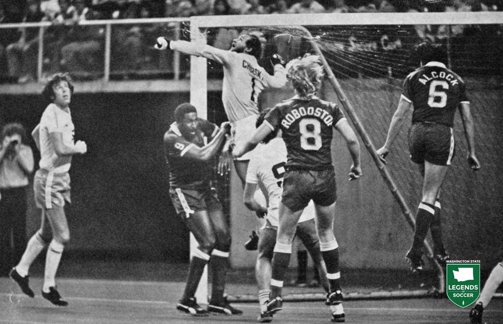 Tony Chursky rises to punch out a Portland cross to Clyde Best.