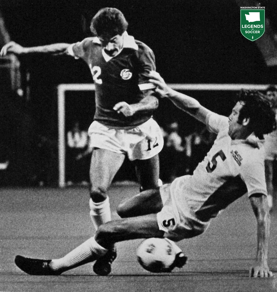 Seattle's Mike England tackles the Cosmos' Seninho. (Frank MacDonald Collection)