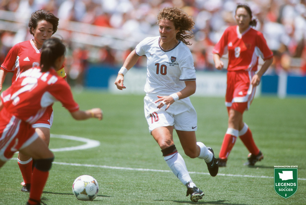 Michelle Akers weaving through traffic vs. China in the 1999 FIFA World Cup final. (Courtesy J Brett Whitesell/ISI Photos)