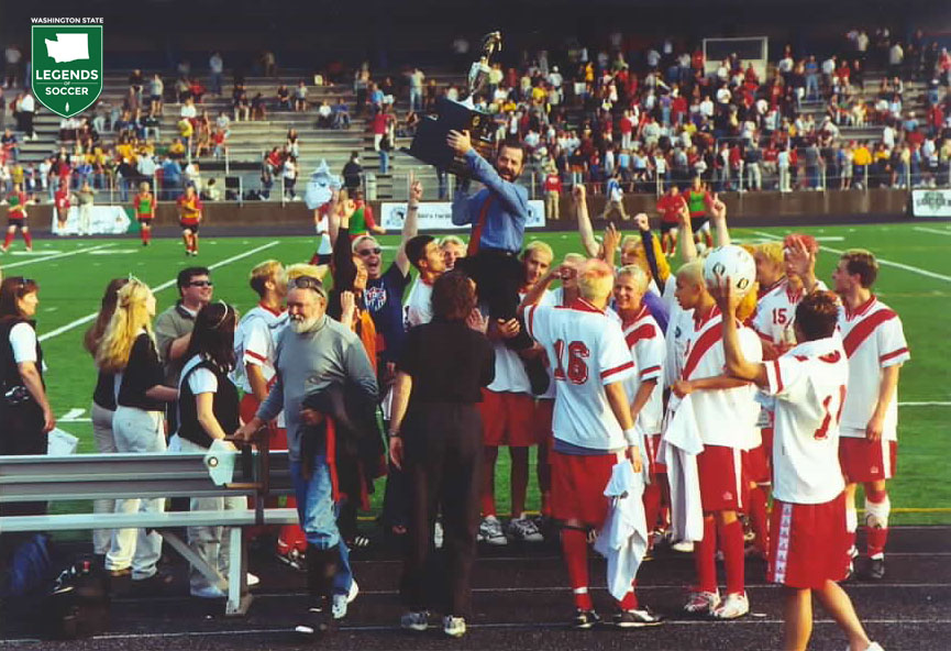 Paul Mendes (with trophy) guided Newport to an unbeaten season and the Knights' second state title (first in 4A) in 2003. (Courtesy Paul Mendes)