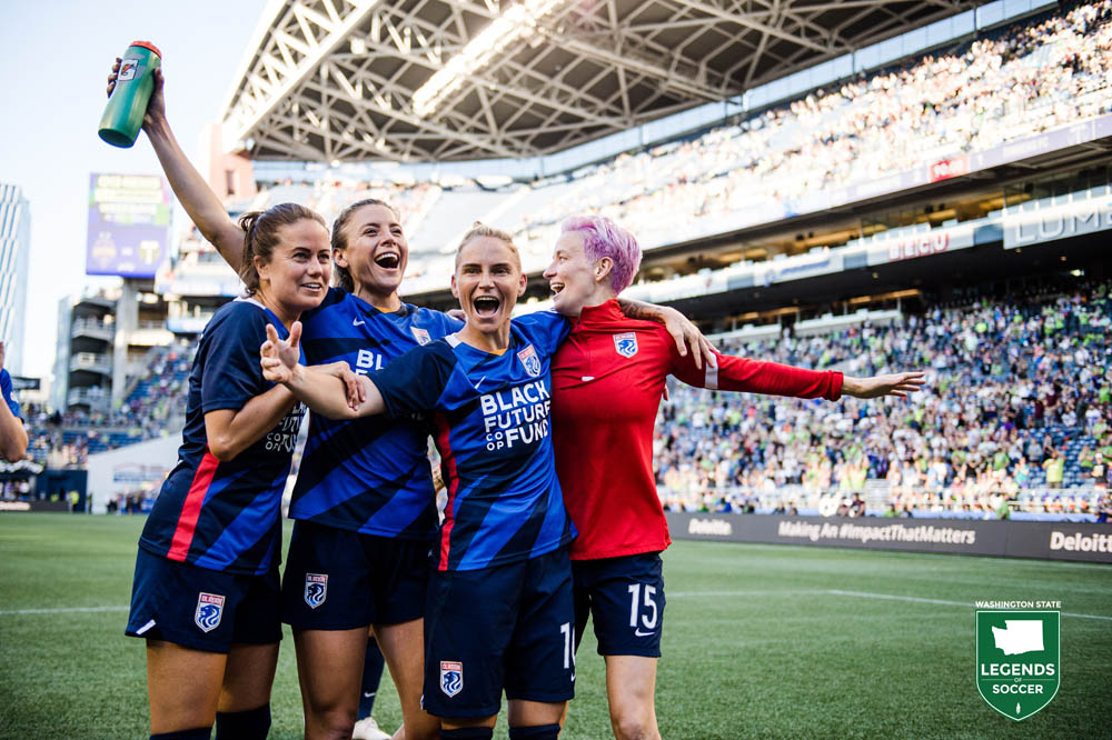 From left, Lauren Barnes, Sofia Huerta, Jessica Fishlock and Megan Rapinoe salute fans among the NWSL-record 27,248 to see OL Reign defeat Portland at Lumen Field. (Courtesy Jane Gershovich)