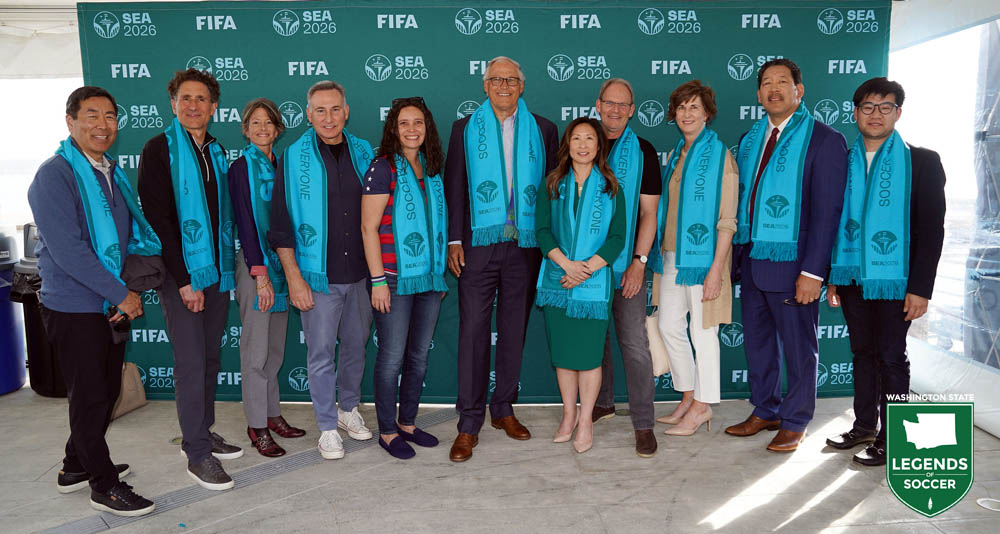 Civic and SEA 2026 leaders pose on Seattle's Pier 62 in celebration of FIFA World Cup matches coming to Lumen Field. (Courtesy Corky Trewin/Sounders FC)